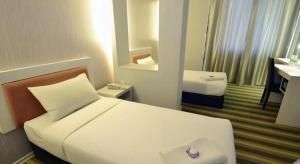 a hotel room with a bed and a bathroom at First Residence Hotel Kemaman in Kampong Gong Pauh