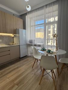 eine Küche und ein Esszimmer mit Tisch und Stühlen in der Unterkunft ЖК Champion с новым ремонтом in Astana