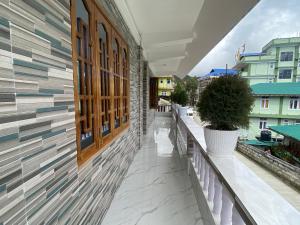 a balcony with tiles on the side of a building at Norkyi Homestay in Tawang +10 photos