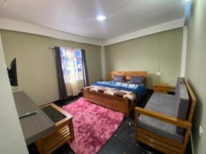 a small bedroom with a bed and a window at Norkyi Homestay in Tawang