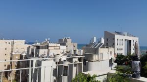 a view of a city with white buildings at Tel Aviv Roof Apartment in Tel Aviv