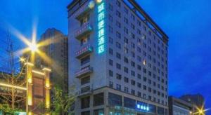 a tall building with blue lights on the side of it at City Comfort lnn Dayi High-speed Railway Station in Chengdu