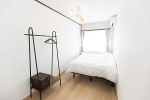 Ένα ή περισσότερα κρεβάτια σε δωμάτιο στο 戸建て貸切 無料駐車場有 名古屋城まで車で10分