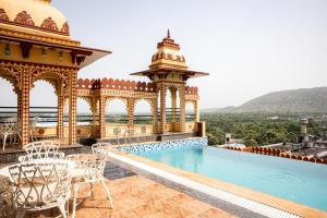 a resort with a swimming pool and a gazebo at Umaid Haveli-A Heritage Style Hotel & Resort in Jaipur