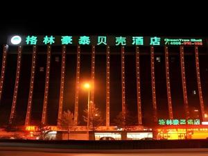 a building with chinese writing on it at night at GreenTree Inn Zhangjiakou Xuanhua Bus Station Shell Hotel in Zhangjiakou