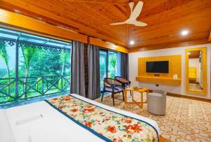 a bedroom with a bed and a large window at The Orchid Rishivan, Rishikesh in Bijni