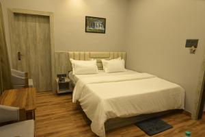 Ένα ή περισσότερα κρεβάτια σε δωμάτιο στο Hotel Paris Garden