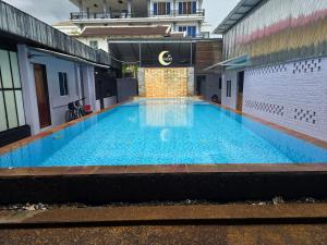 a large blue swimming pool in a building at Lunar Park Guesthouse in Phumi Ta Phul