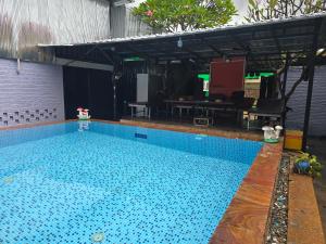 a swimming pool with a large blue pool at Lunar Park Guesthouse in Phumi Ta Phul