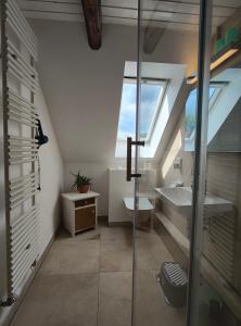 a attic bathroom with a sink and a window at Ferienwohnung Ostermaier in Dresden +19 photos
