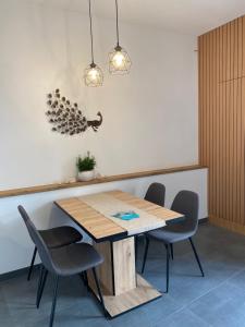 a dining room with a wooden table and chairs at Artinea in Gorizia