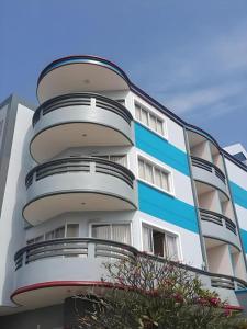 a white and blue building with a balcony at Kiengpiman Hotel in Mukdahan