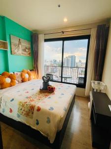 a bedroom with a bed and a large window with a view at The base Central 1006 by Numam in Pattaya +66 photos