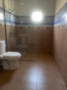 a bathroom with a toilet and a shower and a sink at Villa indi in Wadduwa +9 photos