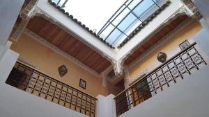 a building with a balcony with a skylight at Dar Nour Fes - Luxury lodging in Fès