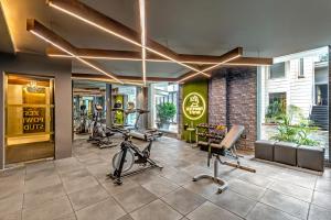 a gym with treadmills and exercise equipment in a building at Sterling Palm Bliss - Rishikesh in Rishīkesh