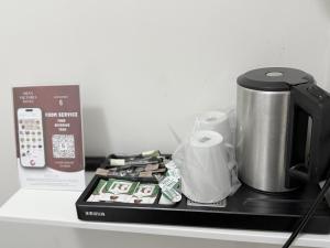 a counter top with a coffee pot and paper towels at Oban Victoria Hotel in London