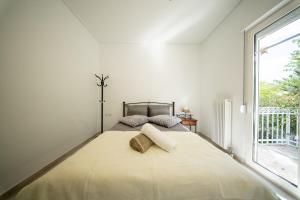 a bedroom with a large bed with a large window at Olive Grove Retreat in Mytilini