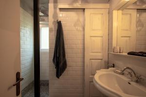 a white bathroom with a sink and a shower at Olive Grove Retreat in Mytilini +60 photos