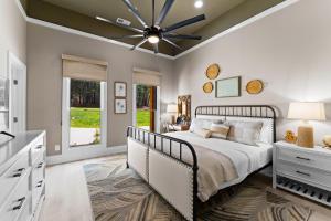 a bedroom with a bed and a ceiling fan at Salience Path w/Heated Pool & Game Room in Mooresville +83 photos