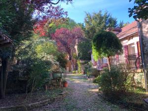 a street in a home with trees and buildings at Les Eaux Calmes in Talcy