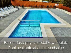 a pool available at an extra charge at Cyrhla Apartamenty - sauna, playroom, free parking & wifi in Zakopane