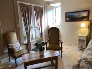 a living room with two chairs and a coffee table at Les Eaux Calmes in Talcy