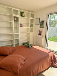 a bedroom with a large bed with shelves at Maison Familiale plain pied à 2km de la mer in Trignac +1 photo