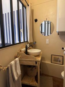 a bathroom with a sink and a mirror at Maison Les Planches Trouville in Trouville-sur-Mer