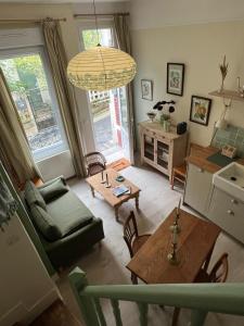 a living room with a couch and a table at Maison Les Planches Trouville in Trouville-sur-Mer +31 photos