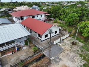 an overhead view of a house with a red roof at Solace Sranan, Modern 2Bedroom Apartment with Garden View near Paramaribo in Wanica
