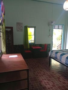 a bedroom with a bed and a couch and a table at Chor Chaba in Ko Kood +21 photos