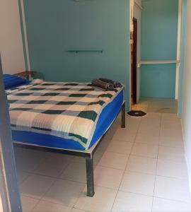 a bed in a room with a blue wall at Happy Days Guest House in Ko Kood +15 photos