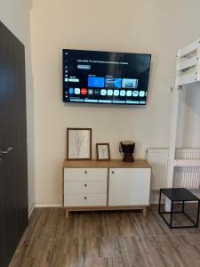 a living room with a tv on the wall at Banija studio apartments in Karlovac