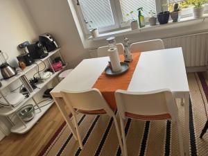 a white table and chairs in a room at Charming room with wonderful view in Vaasa