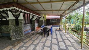 a building with a horse standing in front of it at Cardamom valley Home stay in Vagamon