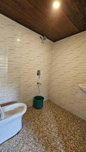 a bathroom with a toilet and a sink at Cardamom valley Home stay in Vagamon
