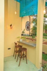 two chairs and a table on a patio at Wind Hill Villa - Weligama in Weligama