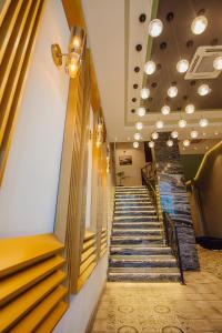 a stairway in a building with escalators at Hotel Neon in Batumi