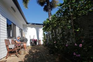 a person sitting on the porch of a house at Happytourcairns sharehouse in Cairns
