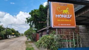 an orangemonkey sign on the side of a building at Monkey Guesthouse - Savannakhet in Savannakhet