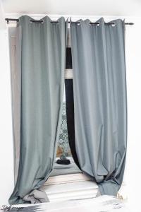 a curtain on a window in a room at Ubuntu House - Charleroi in Charleroi