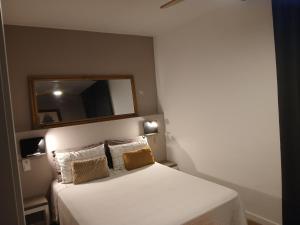 a bedroom with a large white bed with a mirror at Apartaments "Casa Melé" 2 in Lleida +17 photos
