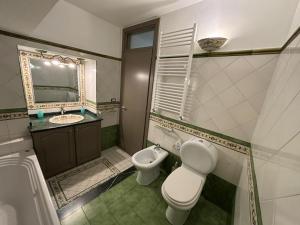 a bathroom with a toilet and a sink at IL moro in Acireale