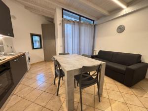 a kitchen and living room with a table and a couch at IL moro in Acireale +14 photos