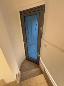 a door leading to a stairway with a glass door at IL moro in Acireale