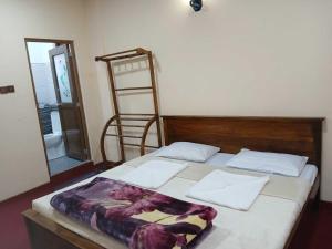 une chambre avec un lit avec une tête de lit en bois dans l'établissement Villa Friendly Faces, à Nuwara Eliya