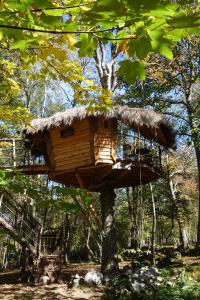 a tree house hanging from a tree at Les Cabanes De Pyrene in Cazarilh
