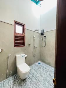 a bathroom with a toilet and a shower at Wind Hill Villa - Weligama in Weligama