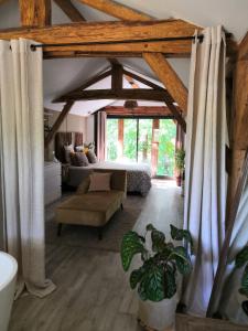 a living room with a bed and a couch at Villa Rustique Le Carriou in Léon